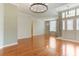Spacious living room featuring polished hardwood floors and a decorative light fixture at 24515 Bocage Way, Leesburg, FL 34748