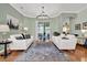 Bright living room with neutral colors, modern lighting, and backyard view at 24515 Bocage Way, Leesburg, FL 34748