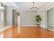Open-concept living area with hardwood floors and sliders to the patio at 24515 Bocage Way, Leesburg, FL 34748