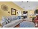 Open concept living room flowing into kitchen with hardwood floors and bright yellow walls at 24515 Bocage Way, Leesburg, FL 34748
