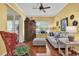 Inviting living room with a blend of modern and antique furnishings, hardwood floors, and bright yellow walls at 24515 Bocage Way, Leesburg, FL 34748