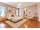 Cozy main bedroom featuring hardwood floors and neutral decor at 24515 Bocage Way, Leesburg, FL 34748