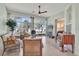 Bright sunroom with lots of natural light, tile flooring, and comfortable wicker furniture at 24515 Bocage Way, Leesburg, FL 34748