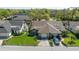 Aerial view of a well-maintained home featuring a green lawn and a two car garage at 2696 Orange Peel Ct, Orlando, FL 32806
