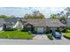 Aerial view of home featuring mature trees, green lawn, and two car garage at 2696 Orange Peel Ct, Orlando, FL 32806