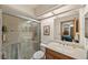 Well-lit bathroom featuring a glass-enclosed shower, a large mirror, and a solid surface vanity at 2696 Orange Peel Ct, Orlando, FL 32806
