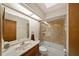 Bathroom featuring a glass-door shower and a wood vanity with a large mirror at 2696 Orange Peel Ct, Orlando, FL 32806