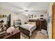 Comfortable bedroom featuring a ceiling fan, a large window, and a dresser at 2696 Orange Peel Ct, Orlando, FL 32806