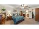 Well-lit bedroom featuring a ceiling fan and a doorway leading to an en suite bathroom at 2696 Orange Peel Ct, Orlando, FL 32806
