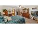 Spacious bedroom featuring a ceiling fan, an ensuite bathroom, and a large wooden dresser at 2696 Orange Peel Ct, Orlando, FL 32806