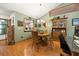 Open dining area with wood floors and a view of the kitchen at 2696 Orange Peel Ct, Orlando, FL 32806