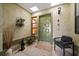 Enclosed front entry with a textured wall finish with bench and decorations at 2696 Orange Peel Ct, Orlando, FL 32806