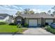 Charming single-story home featuring a well-maintained lawn and attached one car garage at 2696 Orange Peel Ct, Orlando, FL 32806