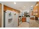 Functional kitchen with white appliances, wood cabinets and tile floors at 2696 Orange Peel Ct, Orlando, FL 32806