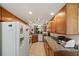 Open kitchen with white appliances, wooden cabinets and granite countertops at 2696 Orange Peel Ct, Orlando, FL 32806