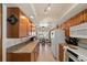 Kitchen featuring wood cabinets and granite countertops; includes modern appliances at 2696 Orange Peel Ct, Orlando, FL 32806