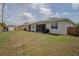 Spacious fenced backyard featuring a shed and solar panels, offering a private outdoor space at 2720 Bancroft Blvd, Orlando, FL 32833