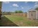 Large fenced backyard with ample lawn space, storage shed, and perfect for outdoor activities at 2720 Bancroft Blvd, Orlando, FL 32833