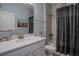 Bright bathroom features a stylish vanity with solid surface countertop and shower with decorative curtain at 2720 Bancroft Blvd, Orlando, FL 32833