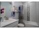 Charming bathroom with a shower and tub combination, zebra shower curtain, and decorative crate shelving at 2720 Bancroft Blvd, Orlando, FL 32833