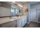 Bathroom with double vanity, quartz countertops, wood look flooring, and framed mirror at 2720 Bancroft Blvd, Orlando, FL 32833