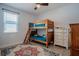Bedroom featuring bunkbeds, ceiling fan, and a dresser with a window for natural light at 2720 Bancroft Blvd, Orlando, FL 32833