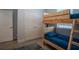 Bedroom featuring wood grain tile, bunk beds, and double door closet for ample storage at 2720 Bancroft Blvd, Orlando, FL 32833