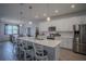 Bright kitchen features a large island, stainless steel appliances, and a dining table at 2720 Bancroft Blvd, Orlando, FL 32833