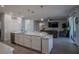 Bright open concept kitchen with island opens to the living room with sliding doors to the exterior at 2720 Bancroft Blvd, Orlando, FL 32833