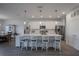 Bright, spacious kitchen with stainless steel appliances, white cabinetry, quartz countertops, and large island with seating at 2720 Bancroft Blvd, Orlando, FL 32833