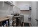 Laundry room features a modern washer/dryer, storage shelves and white cabinets above at 2720 Bancroft Blvd, Orlando, FL 32833