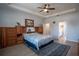 Spacious primary bedroom with a tray ceiling, wood flooring, and a view into the primary bathroom at 2720 Bancroft Blvd, Orlando, FL 32833