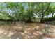 Fenced backyard featuring mature trees and foliage, offering privacy and shade at 305 Hope Cir, Orlando, FL 32811