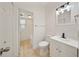 This bathroom includes a white vanity, a toilet, and a shower-tub combo with white tiling at 305 Hope Cir, Orlando, FL 32811