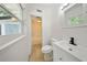 This bathroom includes a white vanity, a toilet, and a shower-tub combo with white tiling at 305 Hope Cir, Orlando, FL 32811