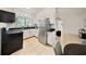 Functional kitchen featuring white cabinets, stainless steel appliances, and a black countertop at 305 Hope Cir, Orlando, FL 32811