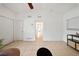 Spacious living room with neutral tiles, white walls and ceiling, two doors, and a modern console table at 305 Hope Cir, Orlando, FL 32811