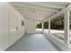 Enclosed porch with multiple large windows and a white ceiling and wall paint throughout at 305 Hope Cir, Orlando, FL 32811