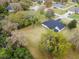 Aerial view of home showcasing expansive yard and surrounding neighborhood at 30912 Fairvista Dr, Tavares, FL 32778