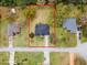 Aerial view with property lines, showcasing the home and its large, tree-filled lot at 30912 Fairvista Dr, Tavares, FL 32778