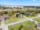 Aerial view of the home, showcasing the neighborhood and nearby lake at 30912 Fairvista Dr, Tavares, FL 32778