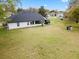 Spacious backyard view with a large lawn and the home's exterior at 30912 Fairvista Dr, Tavares, FL 32778