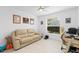 Bright bedroom with a sofa, desk, and a large window with natural light at 30912 Fairvista Dr, Tavares, FL 32778