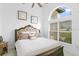 Comfortable bedroom featuring a cozy bed, a large window, and overhead lighting at 30912 Fairvista Dr, Tavares, FL 32778