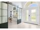 Bright entrance hall featuring a barn door and a view into an office at 30912 Fairvista Dr, Tavares, FL 32778