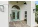 Welcoming home entrance with bright double doors and stone floors at 30912 Fairvista Dr, Tavares, FL 32778