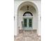 Inviting entryway featuring double doors and a charming welcome sign at 30912 Fairvista Dr, Tavares, FL 32778
