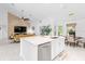 Bright, open concept kitchen with a large island, stainless steel appliances, and seamless flow to the living area at 30912 Fairvista Dr, Tavares, FL 32778