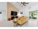Inviting living room featuring a vaulted ceiling and decorative stone wall at 30912 Fairvista Dr, Tavares, FL 32778
