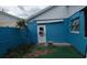 Quaint backyard area with unique siding and mature landscaping at 3243 Little Sound Dr, Orlando, FL 32827